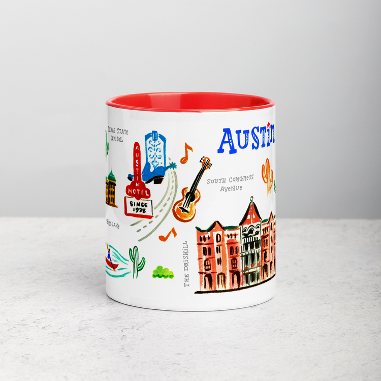 White ceramic coffee mug with red handle and inside; has Austin landmarks illustration by Angela Staehling
