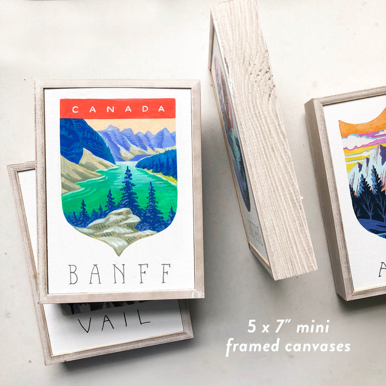 Banff National Park framed art with Rocky Mountains, glacial lakes, and coniferous forest; trendy illustration by Angela Staehling