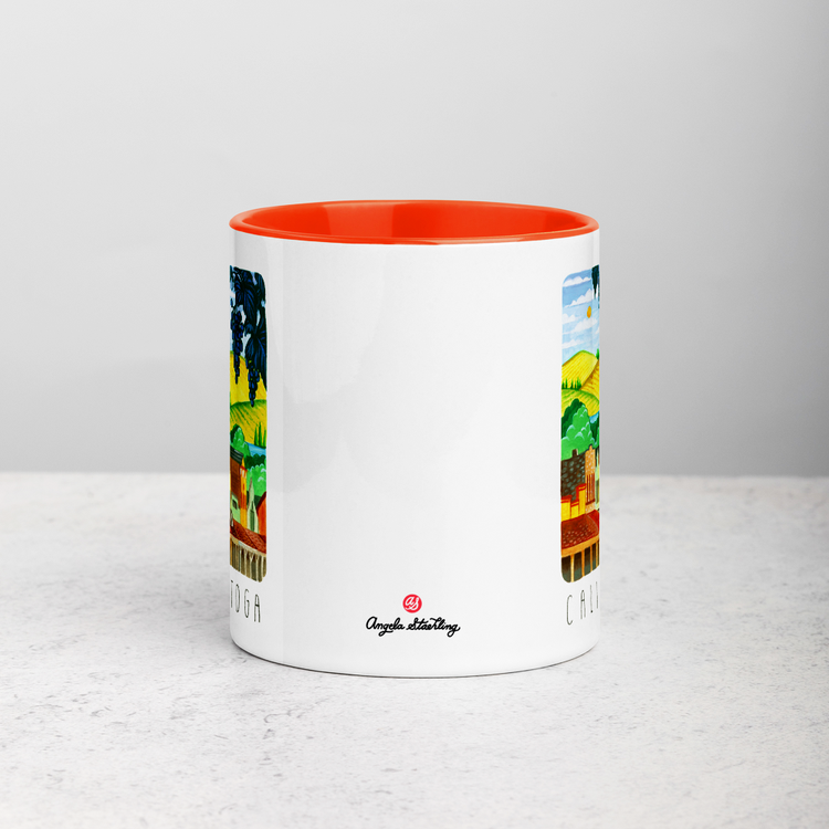 White ceramic coffee mug with orange handle and inside; has Calistoga California illustration by Angela Staehling