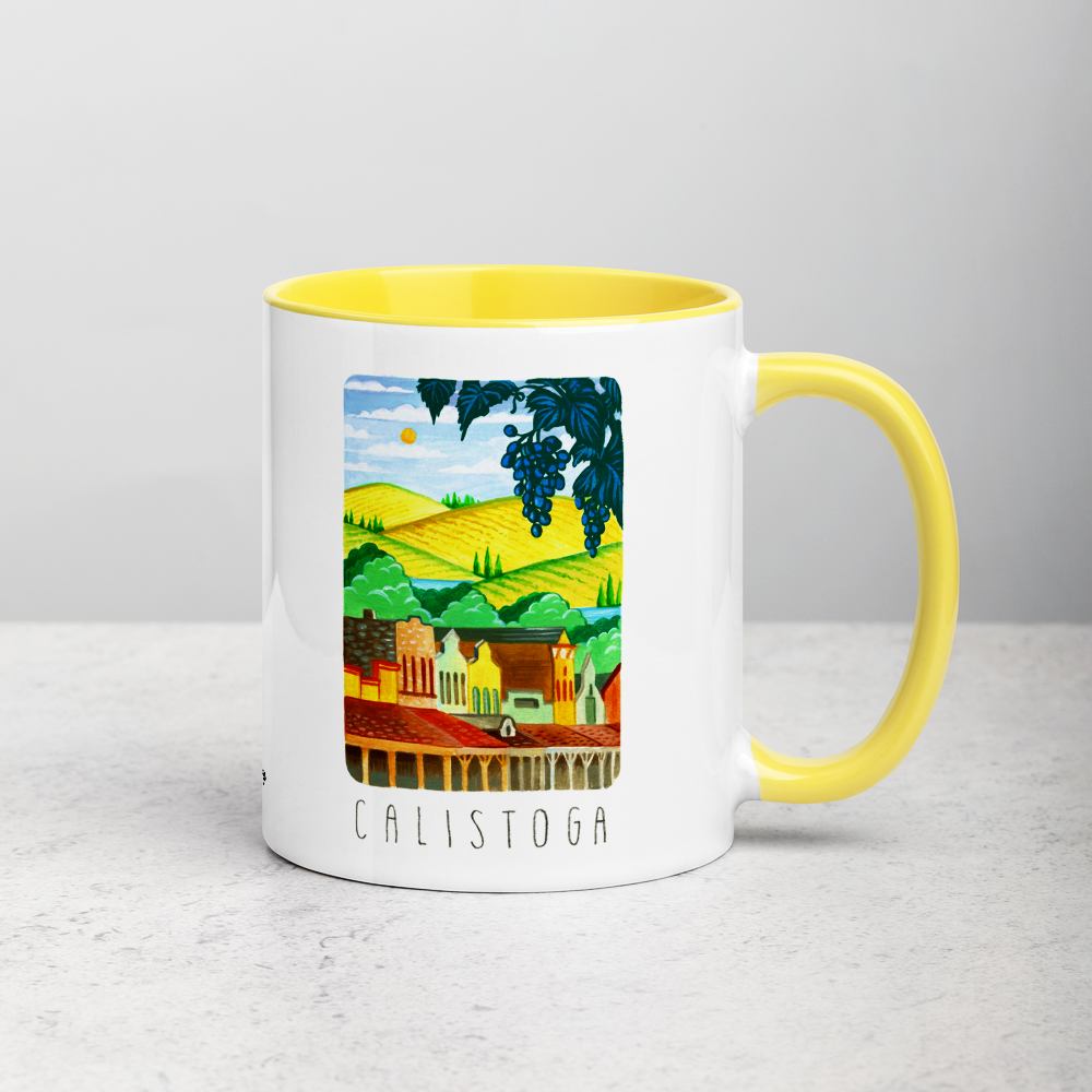 White ceramic coffee mug with yellow handle and inside; has Calistoga California illustration by Angela Staehling
