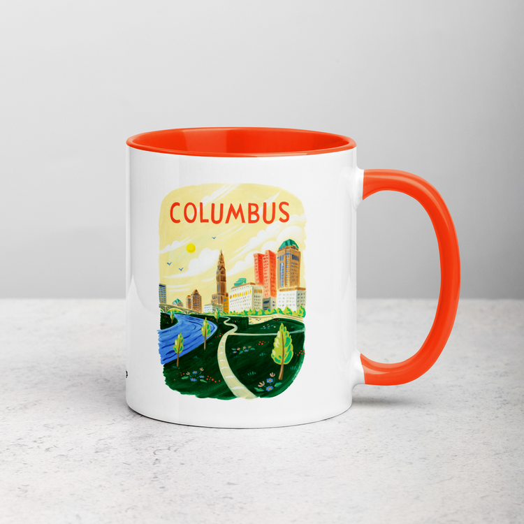 White ceramic coffee mug with orange handle and inside; has Columbus Ohio illustration by Angela Staehling