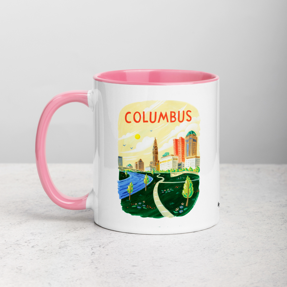 White ceramic coffee mug with pink handle and inside; has Columbus Ohio illustration by Angela Staehling