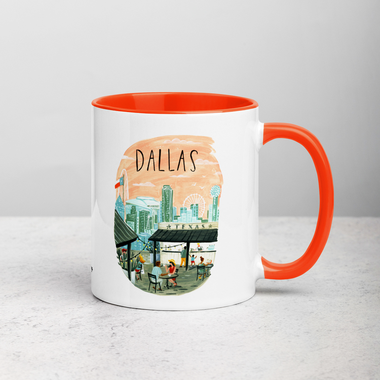 White ceramic coffee mug with orange handle and inside; has Dallas Texas illustration by Angela Staehling