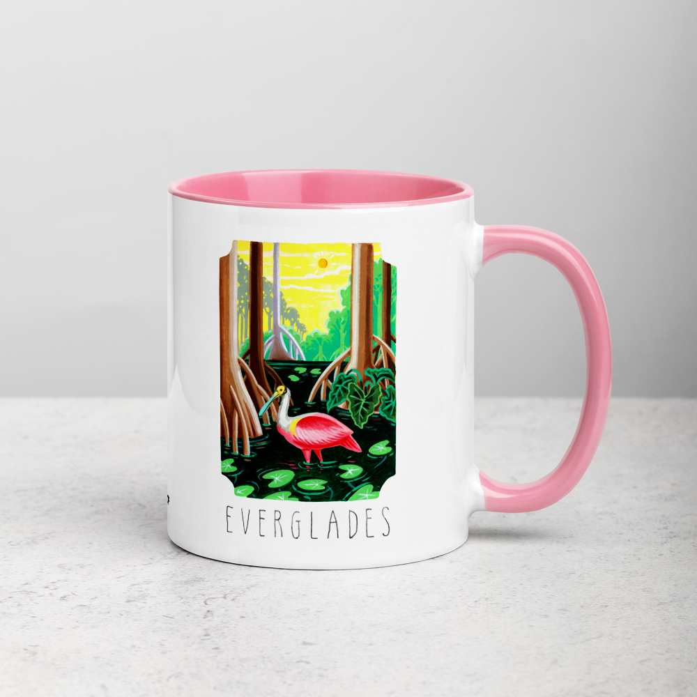 White ceramic coffee mug with pink handle and inside; has Everglades National Park illustration by Angela Staehling
