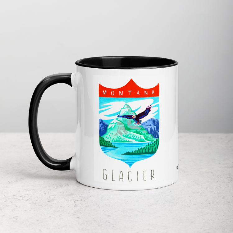 White ceramic coffee mug with black handle and inside; has Glacier National Park illustration by Angela Staehling