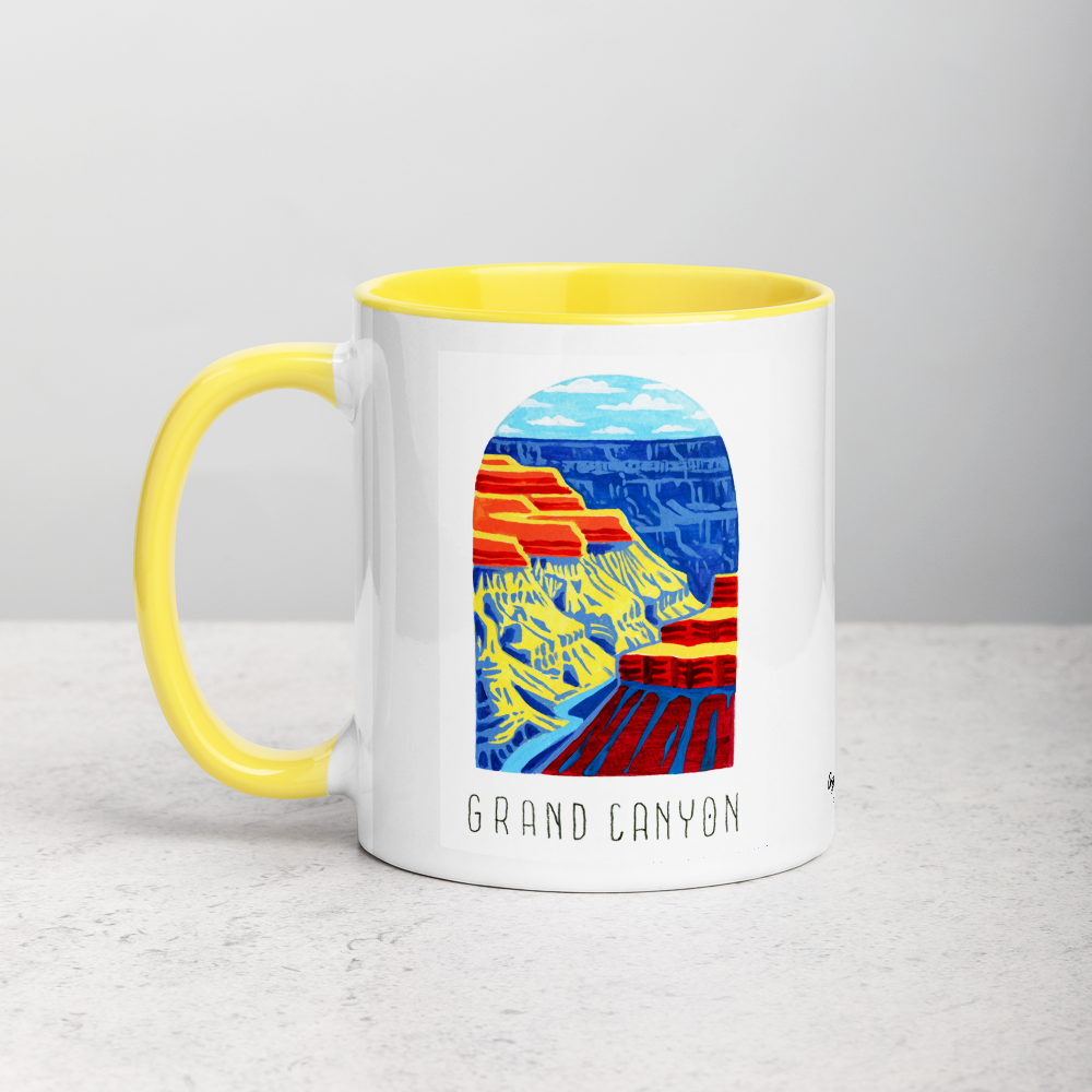 White ceramic coffee mug with yellow handle and inside; has Grand Canyon National Park illustration by Angela Staehling