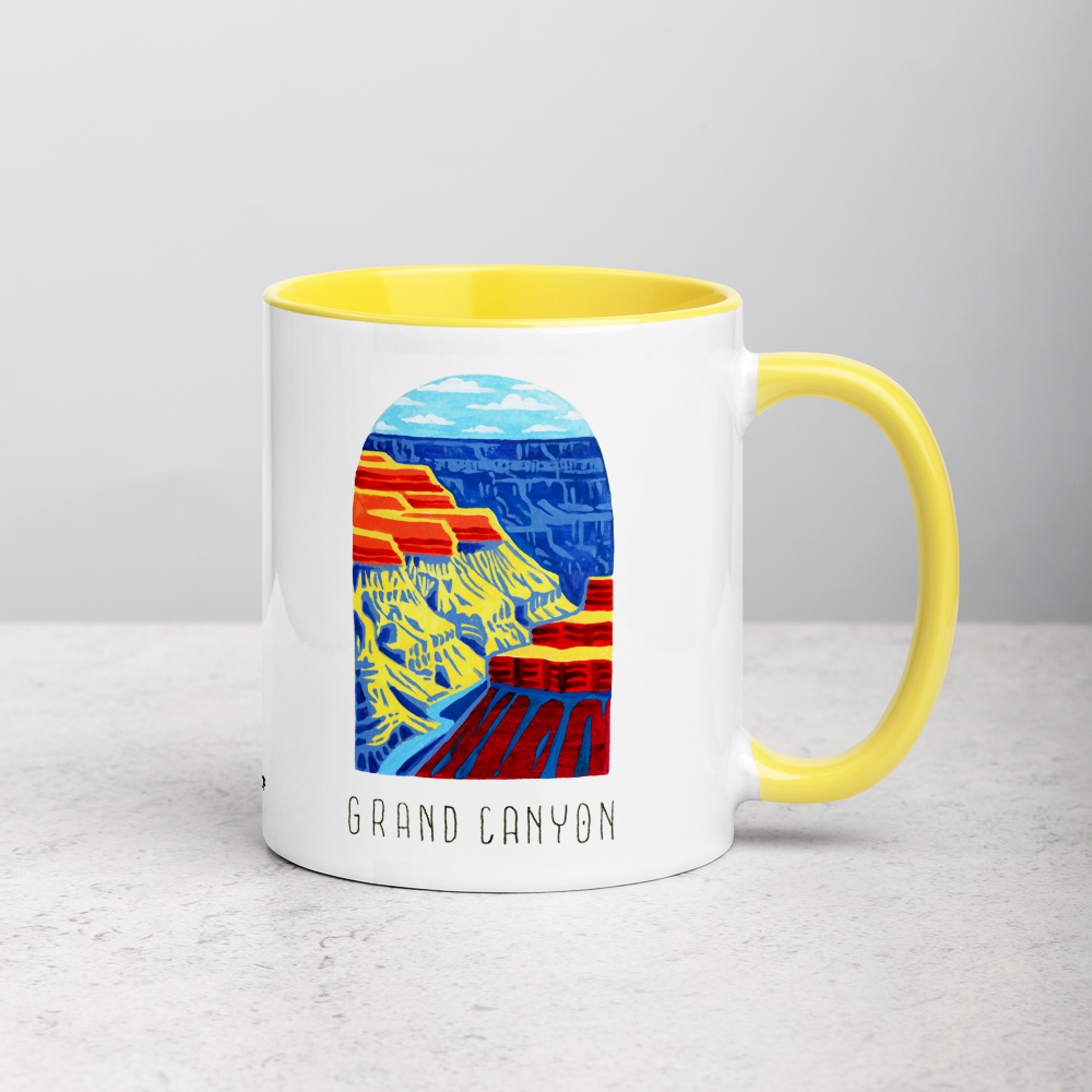 White ceramic coffee mug with yellow handle and inside; has Grand Canyon National Park illustration by Angela Staehling