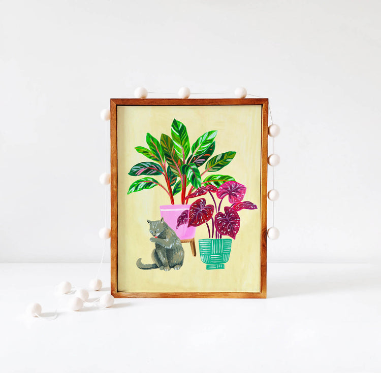 Gray cat and houseplant illustration in wood frame