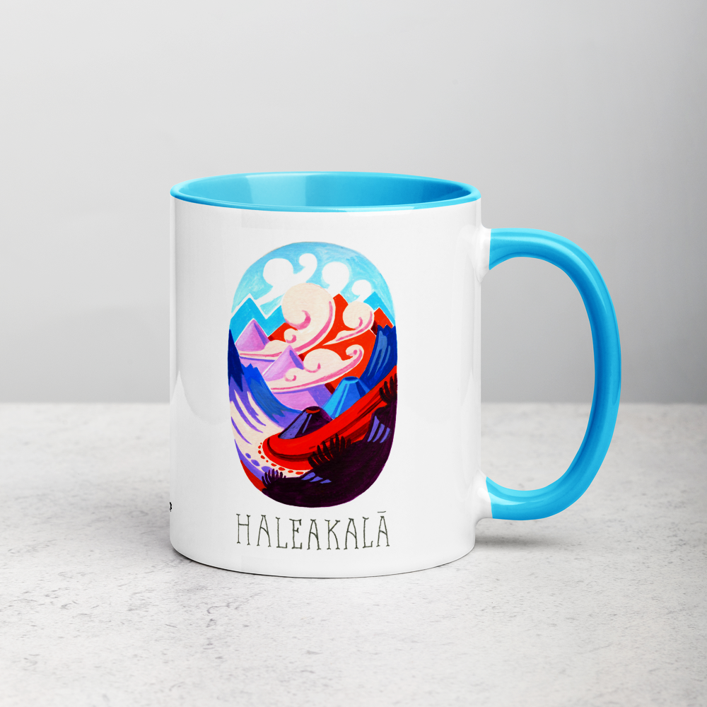 White ceramic coffee mug with blue handle and inside; has Haleakala National Park illustration by Angela Staehling