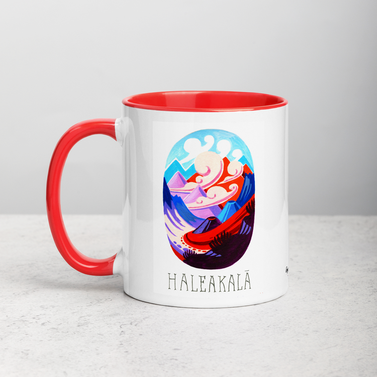 White ceramic coffee mug with red handle and inside; has Haleakala National Park illustration by Angela Staehling