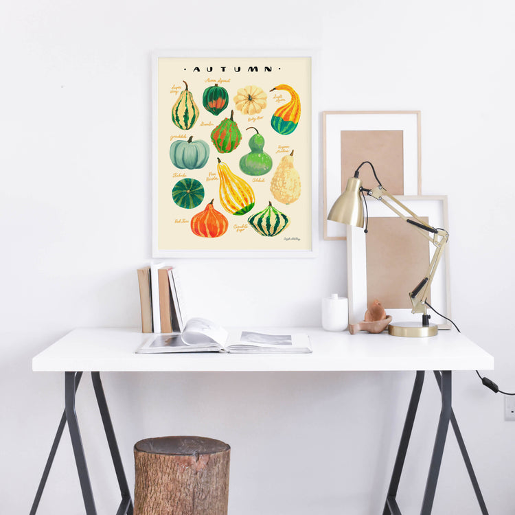Harvest gourds illustration in white frame about desk