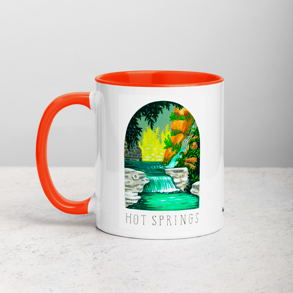 White ceramic coffee mug with orange handle and inside; has Hot Springs National Park illustration by Angela Staehling