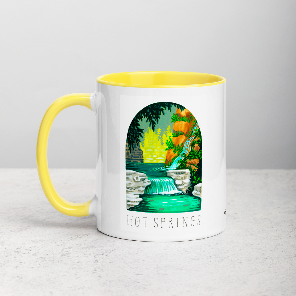 White ceramic coffee mug with yellow handle and inside; has Hot Springs National Park illustration by Angela Staehling