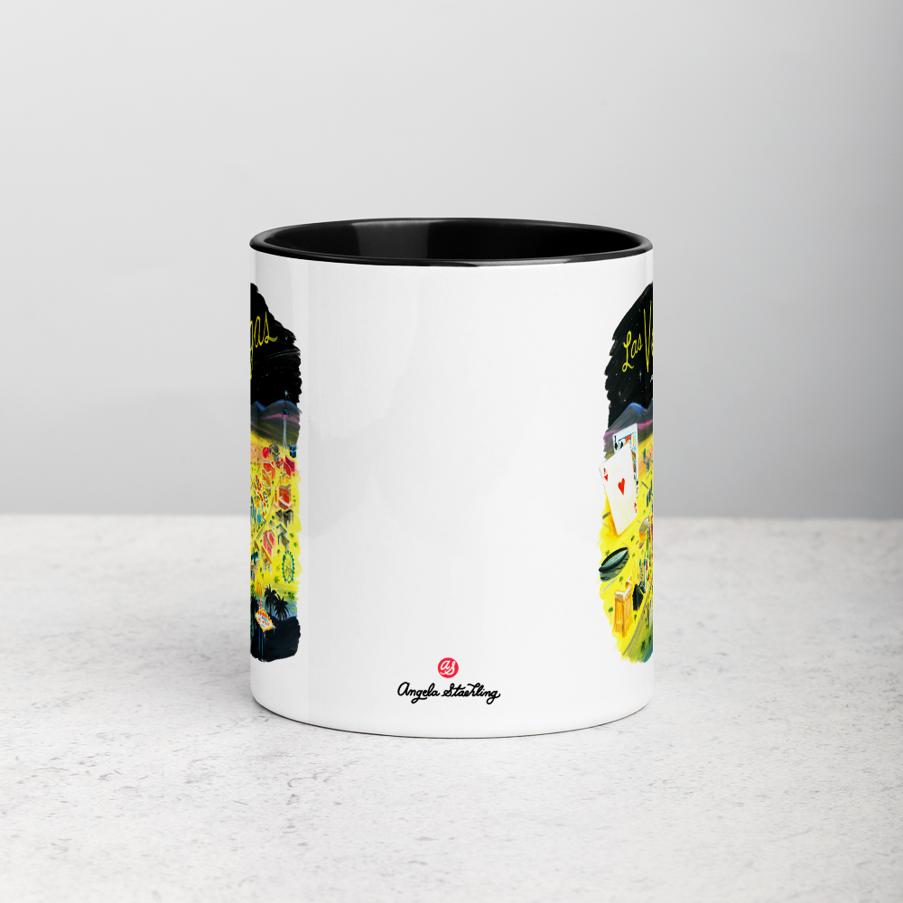 White ceramic coffee mug with black handle and inside; has Las Vegas illustration by Angela Staehling
