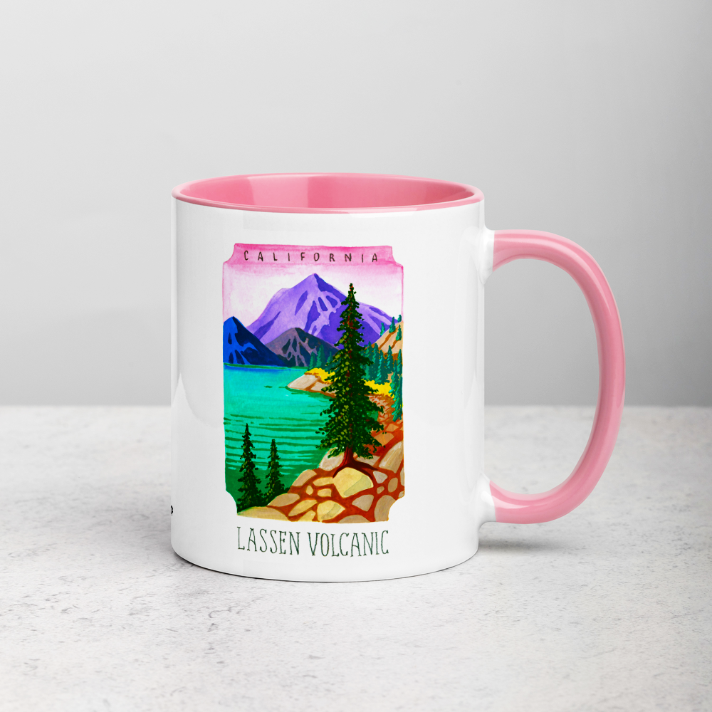 White ceramic coffee mug with pink handle and inside; has Lassen Volcanic National Park illustration by Angela Staehling