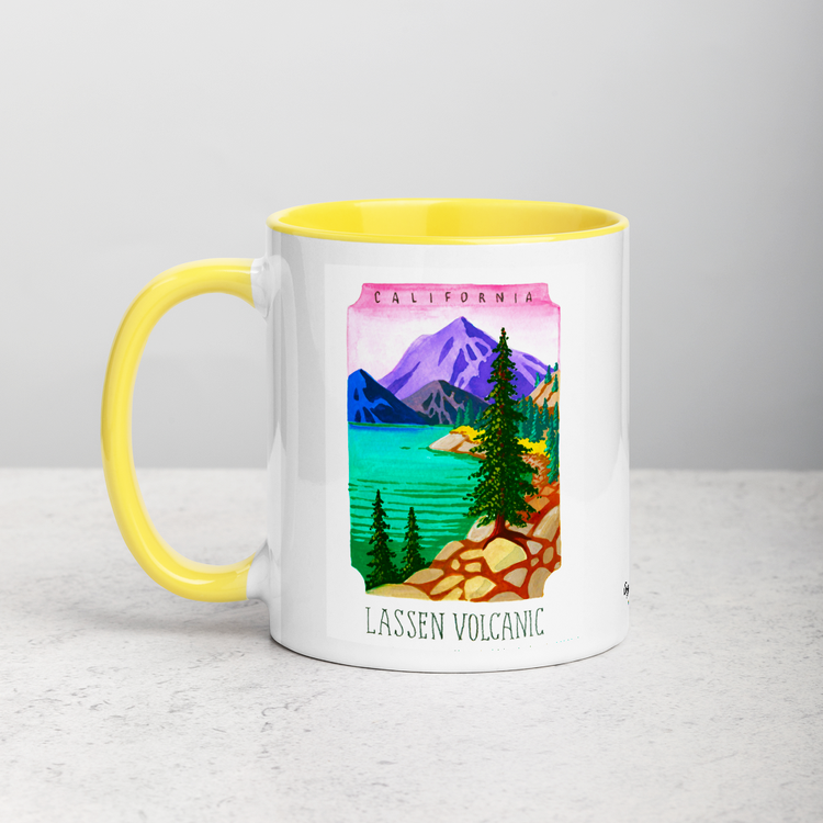 White ceramic coffee mug with yellow handle and inside; has Lassen Volcanic National Park illustration by Angela Staehling