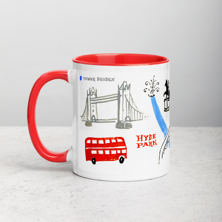 White ceramic coffee mug with red handle and inside; has London landmarks illustration by Angela Staehling