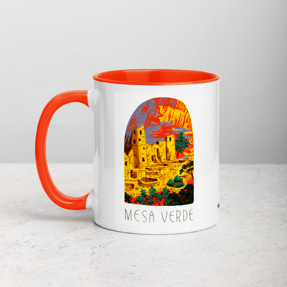 White ceramic coffee mug with orange handle and inside; has Mesa Verde National Park illustration by Angela Staehling