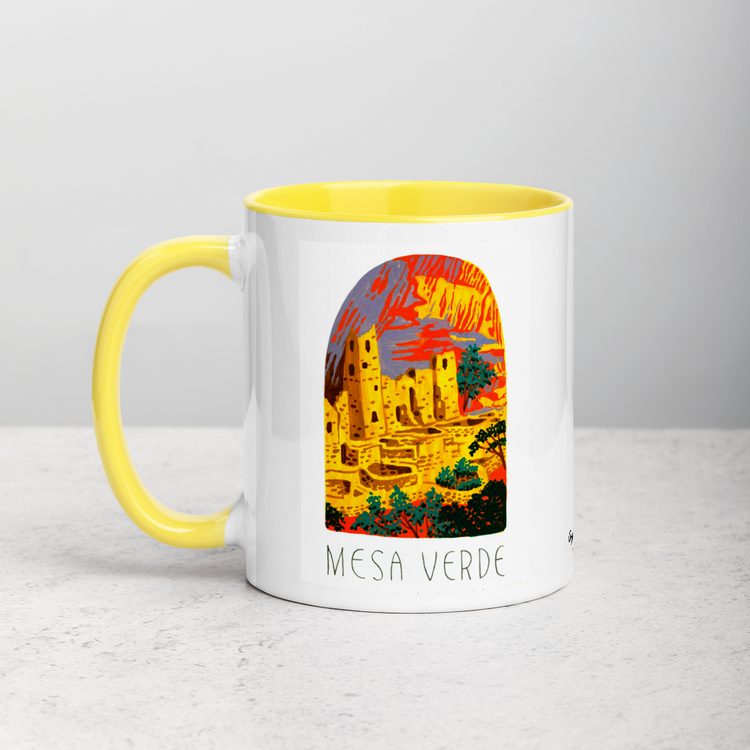 White ceramic coffee mug with yellow handle and inside; has Mesa Verde National Park illustration by Angela Staehling