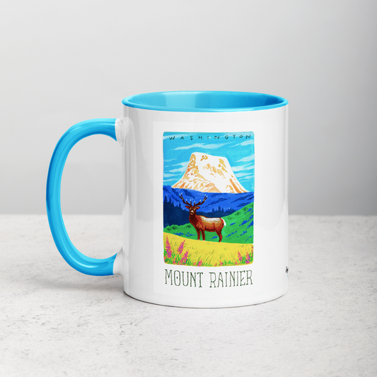 White ceramic coffee mug with blue handle and inside; has Mount Rainier National Park illustration by Angela Staehling