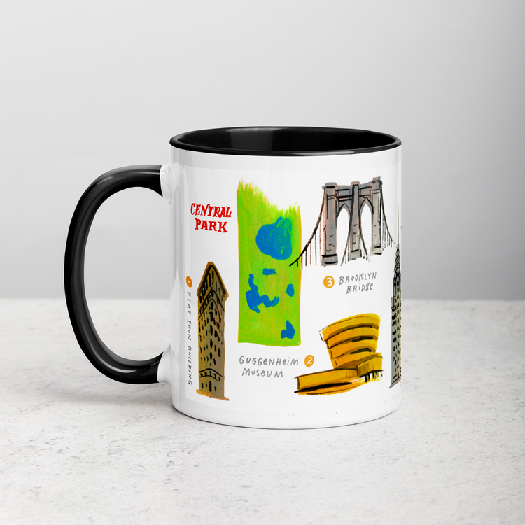 White ceramic coffee mug with black handle and inside; has New York landmarks illustration by Angela Staehling