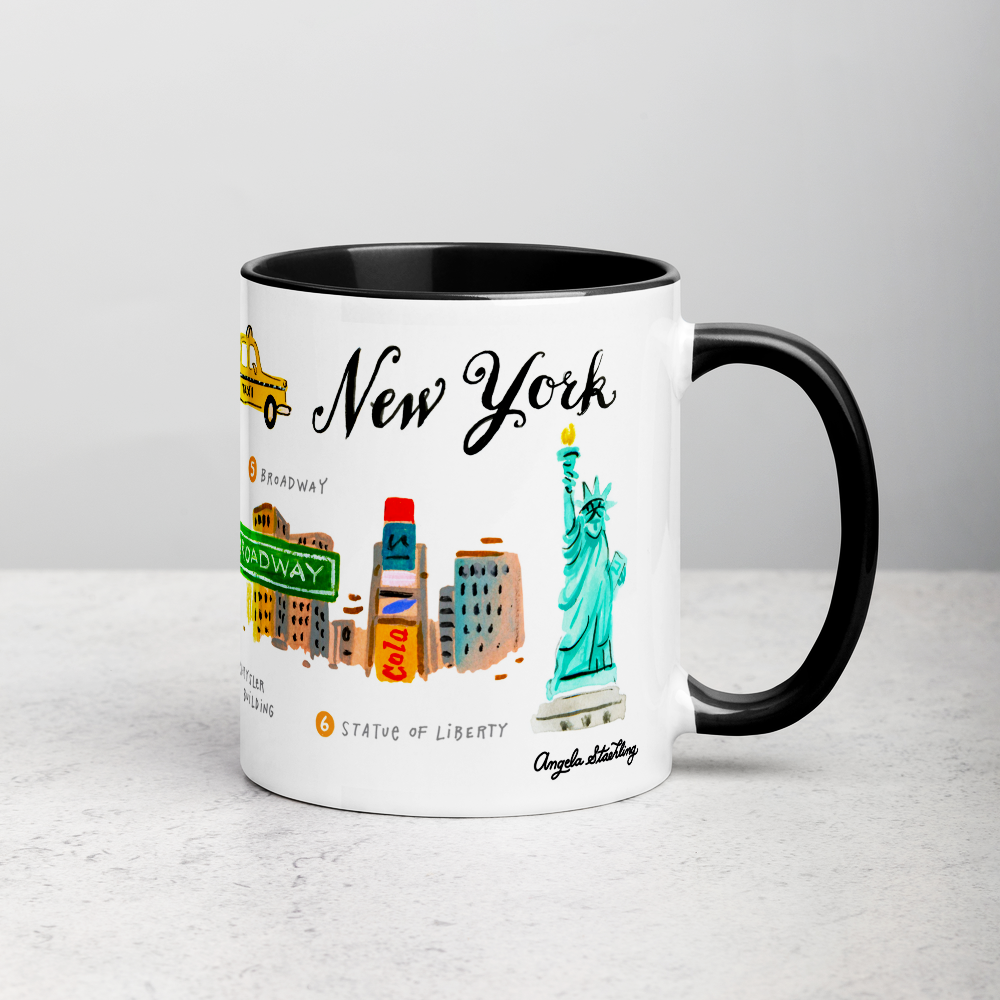 White ceramic coffee mug with black handle and inside; has New York landmarks illustration by Angela Staehling