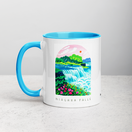 White ceramic coffee mug with blue handle and inside; has Niagara Falls National Park illustration by Angela Staehling