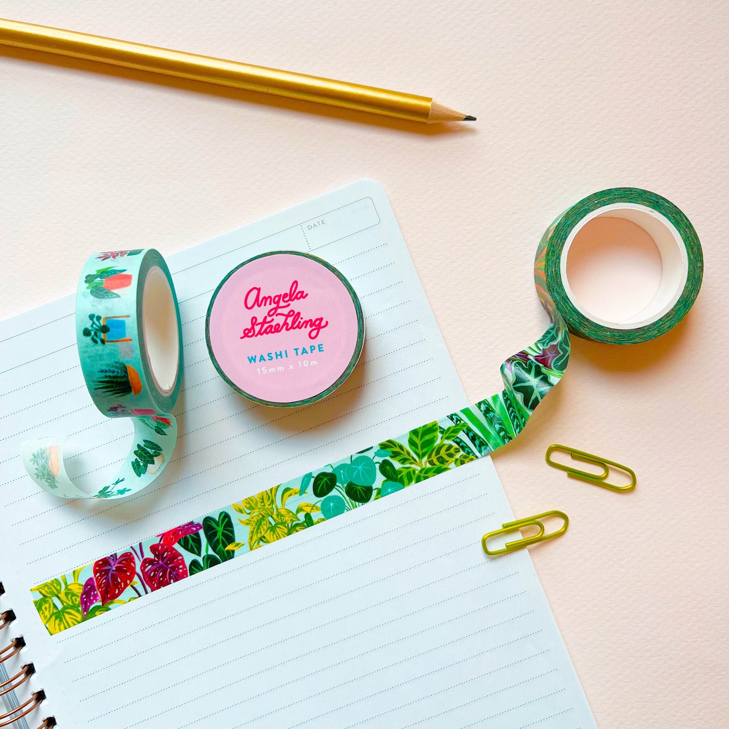 Plant washi tape with houseplant washi tape, paper clips, notebook, and pencil