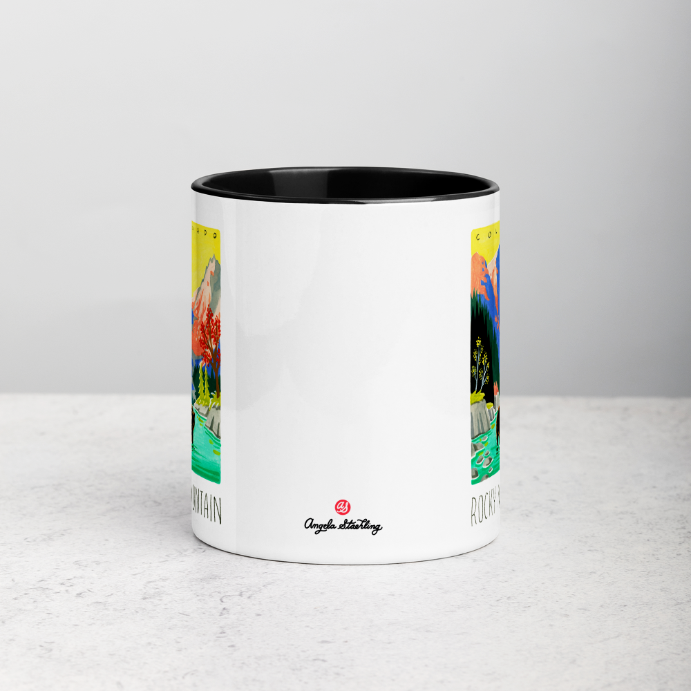 White ceramic coffee mug with black handle and inside; has Rocky Mountain National Park illustration by Angela Staehling