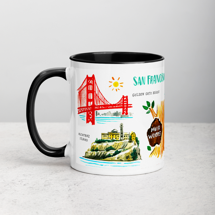 White ceramic coffee mug with black handle and inside; has San Francisco landmarks illustration by Angela Staehling