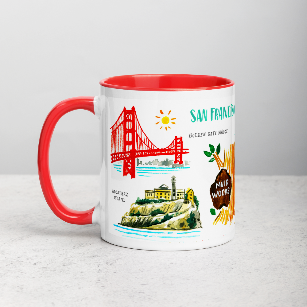 White ceramic coffee mug with red handle and inside; has San Francisco landmarks illustration by Angela Staehling