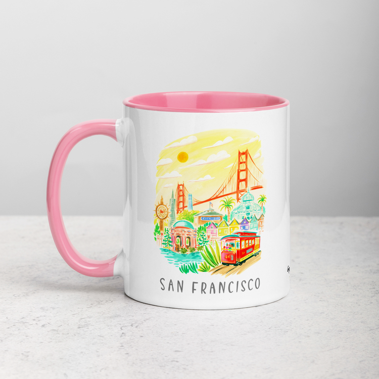 White ceramic coffee mug with pink handle and inside; has San Francisco Golden Gate illustration by Angela Staehling