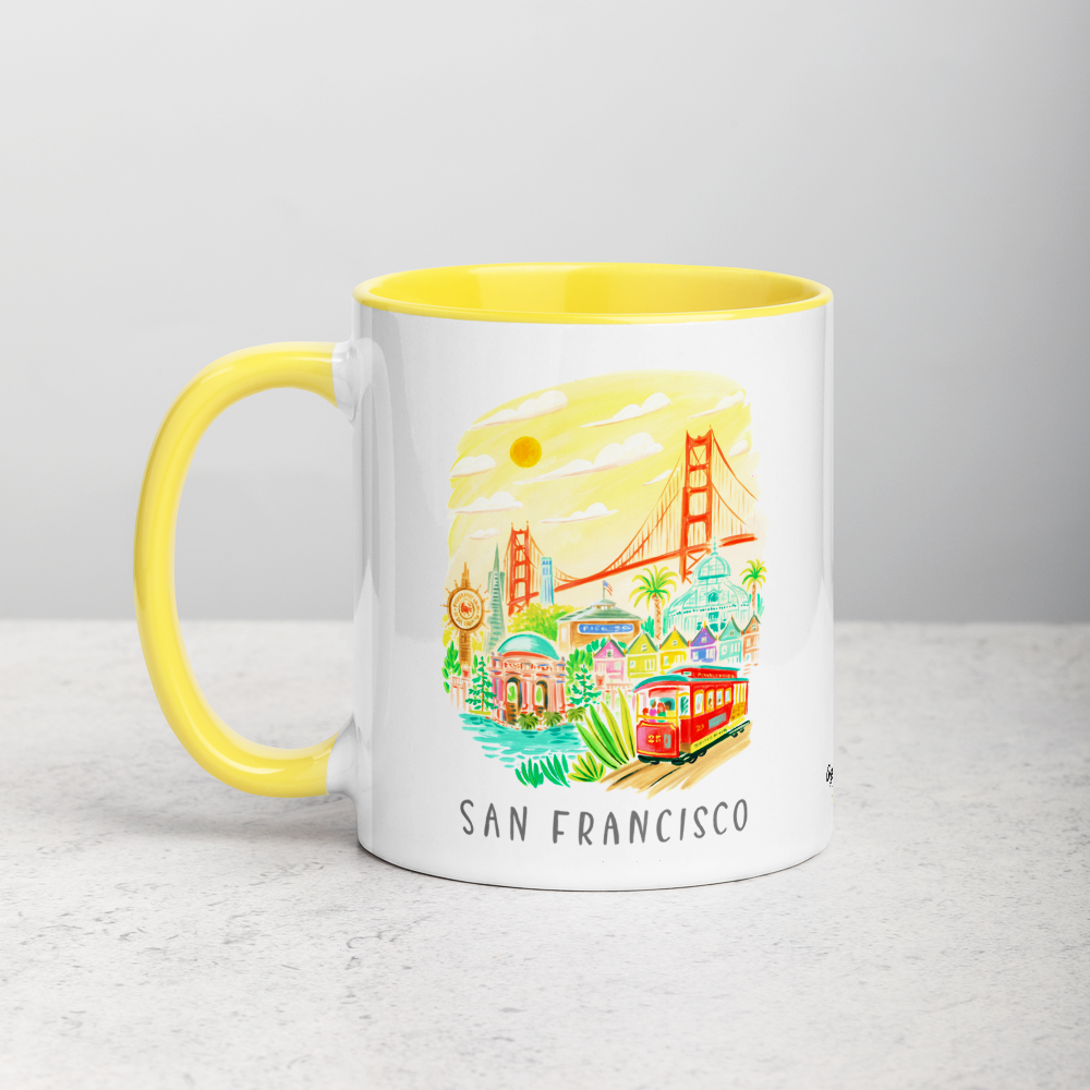 White ceramic coffee mug with yellow handle and inside; has San Francisco Golden Gate illustration by Angela Staehling
