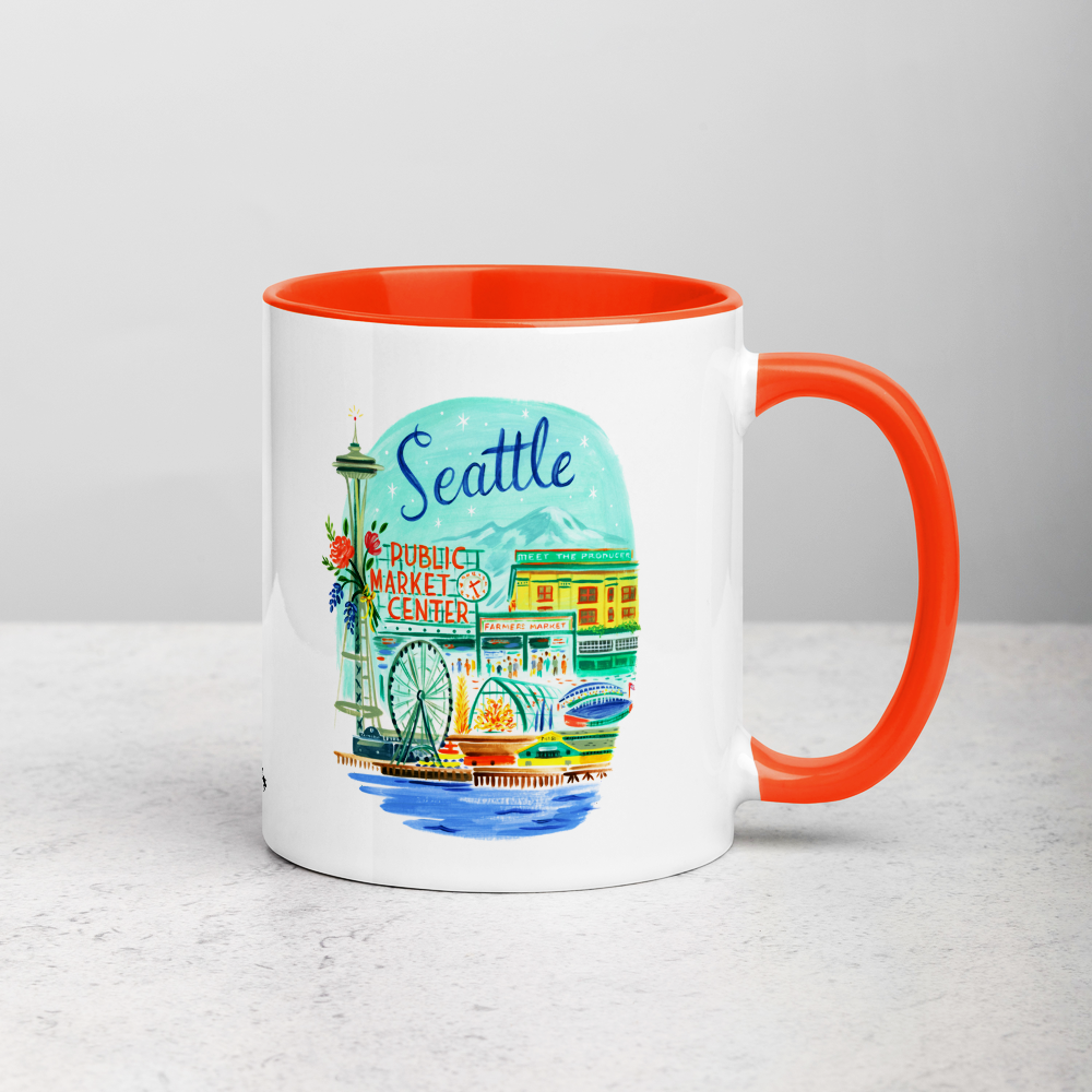 White ceramic coffee mug with orange handle and inside; has Seattle Washington illustration by Angela Staehling