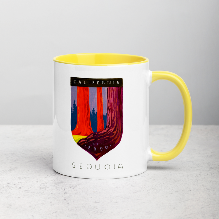 White ceramic coffee mug with yellow handle and inside; has Sequoia National Park illustration by Angela Staehling