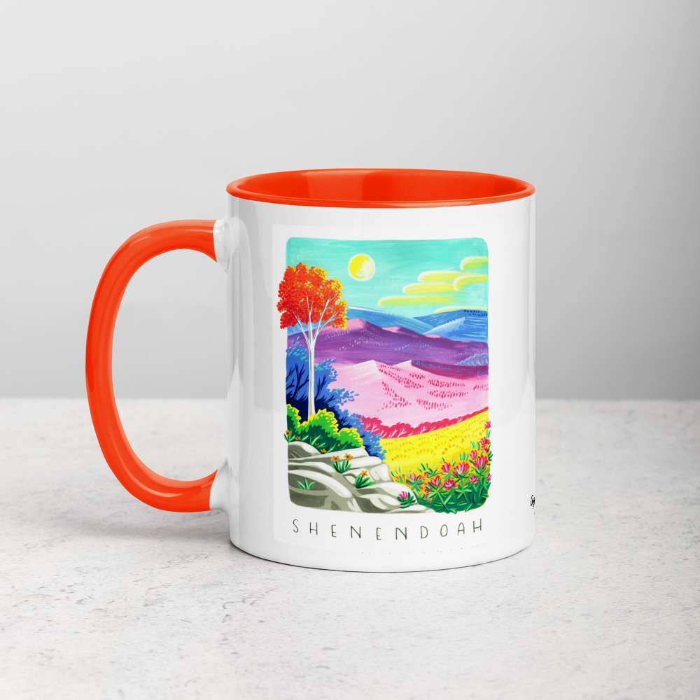 White ceramic coffee mug with orange handle and inside; has Shenandoah National Park illustration by Angela Staehling