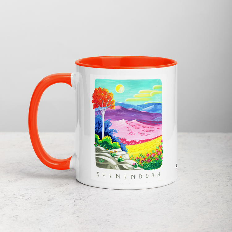 White ceramic coffee mug with orange handle and inside; has Shenandoah National Park illustration by Angela Staehling