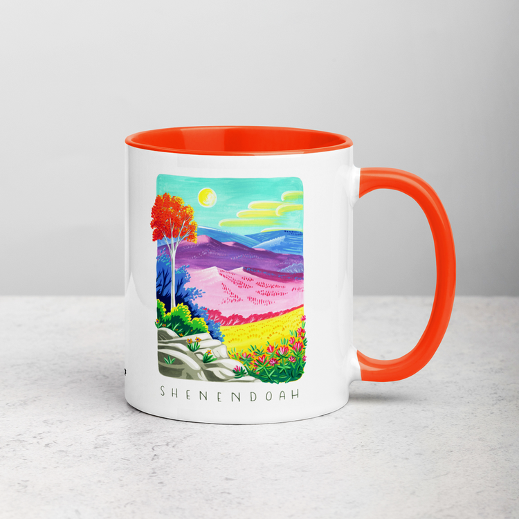 White ceramic coffee mug with orange handle and inside; has Shenandoah National Park illustration by Angela Staehling