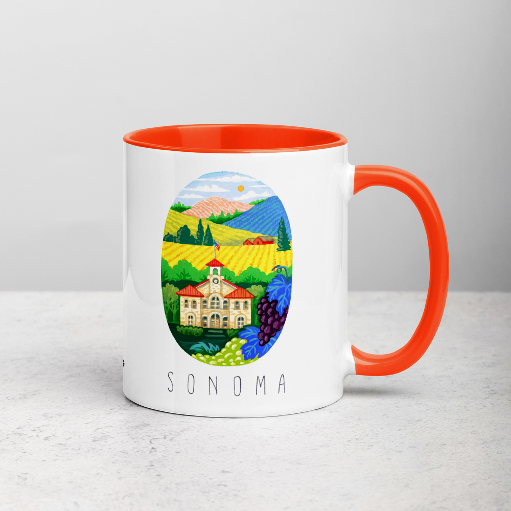 White ceramic coffee mug with orange handle and inside; has Sonoma Valley California illustration by Angela Staehling