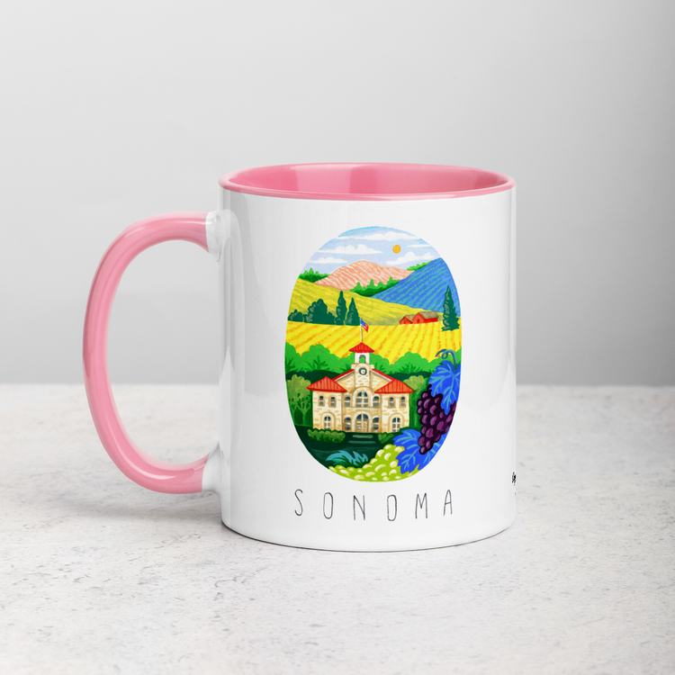 White ceramic coffee mug with pink handle and inside; has Sonoma Valley California illustration by Angela Staehling