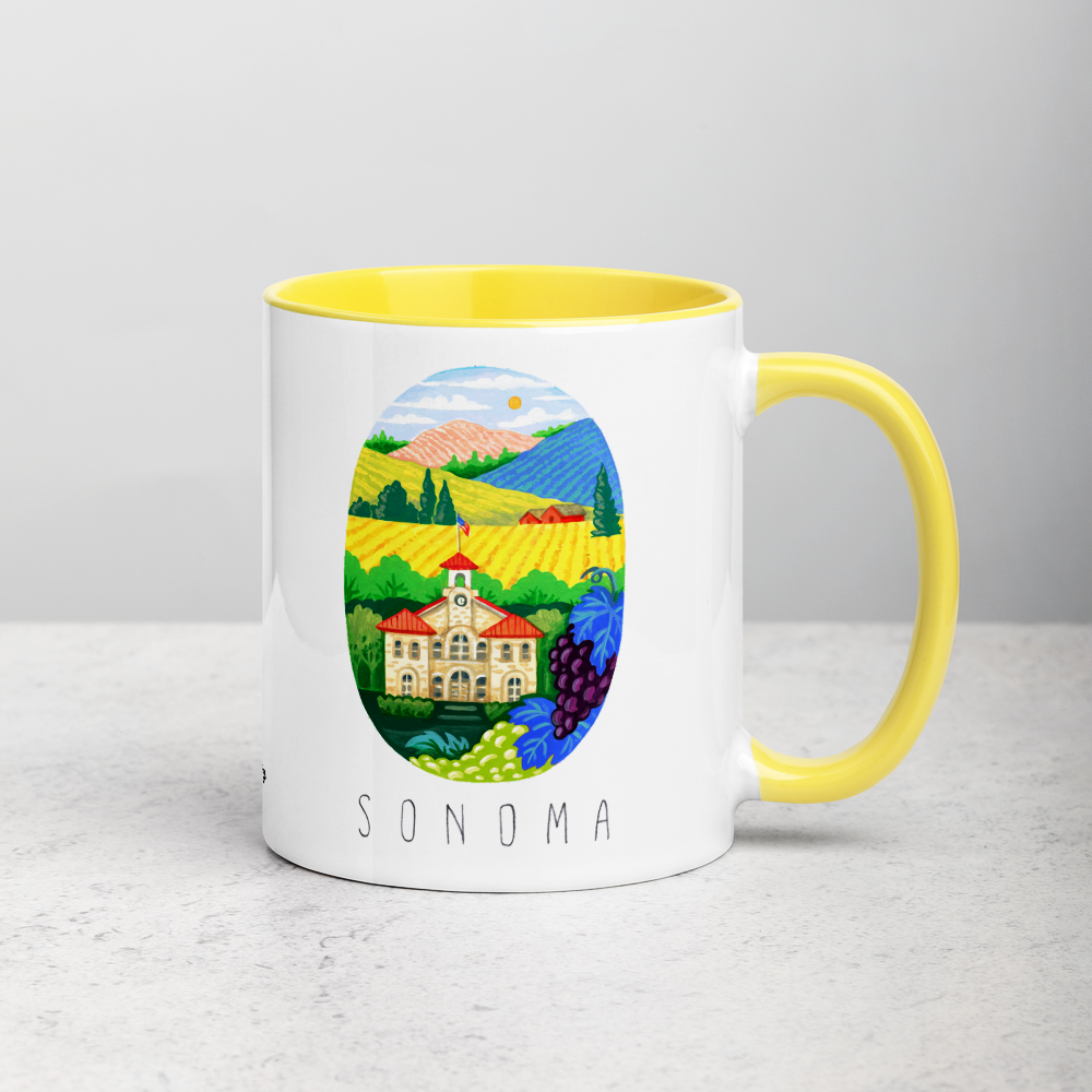 White ceramic coffee mug with yellow handle and inside; has Sonoma Valley California illustration by Angela Staehling