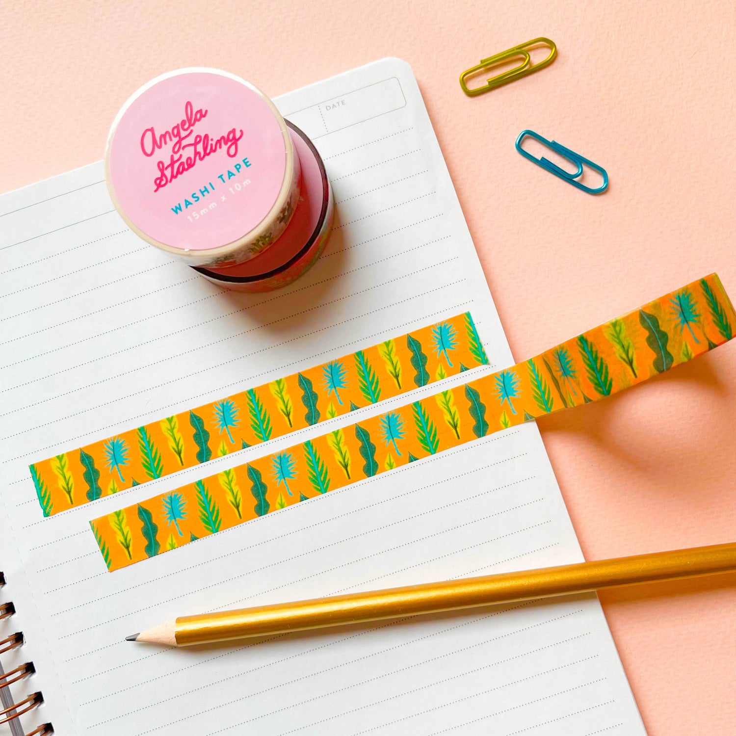 Golden yellow washi tape with palm leaves on paper