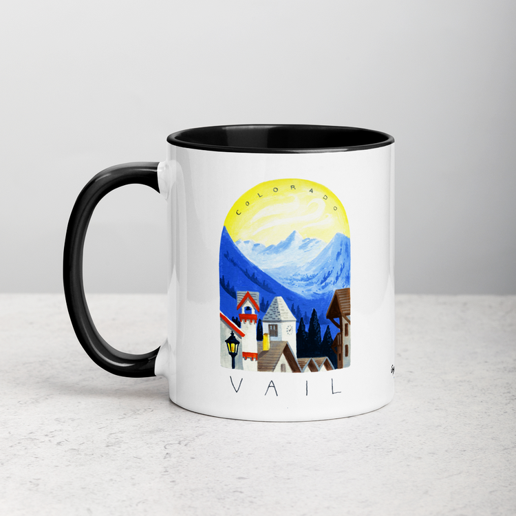 White ceramic coffee mug with black handle and inside; has Sonoma Vail Colorado illustration by Angela Staehling