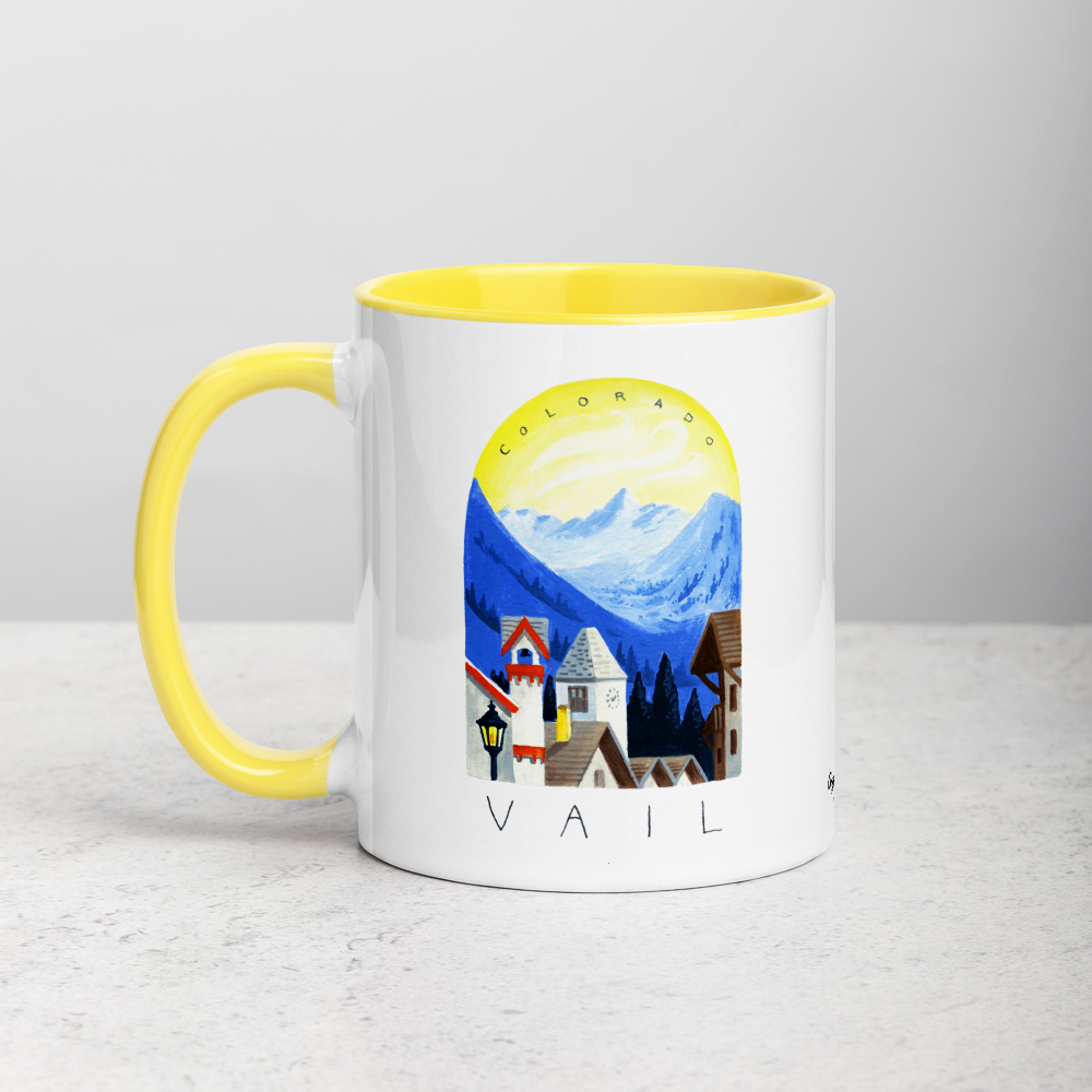 White ceramic coffee mug with yellow handle and inside; has Sonoma Vail Colorado illustration by Angela Staehling