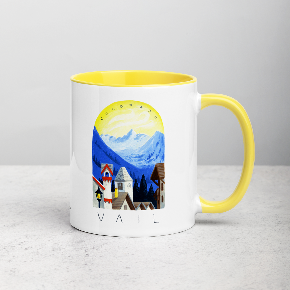 White ceramic coffee mug with yellow handle and inside; has Sonoma Vail Colorado illustration by Angela Staehling