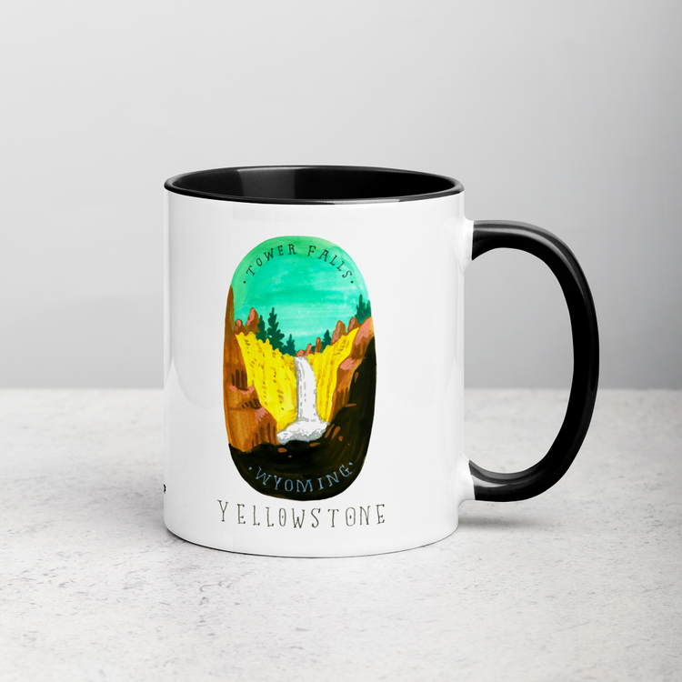 White ceramic coffee mug with black handle and inside; has Yellowstone National Park illustration by Angela Staehling