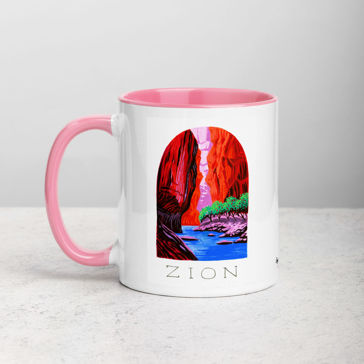 White ceramic coffee mug with pink handle and inside; has Zion National Park illustration by Angela Staehling